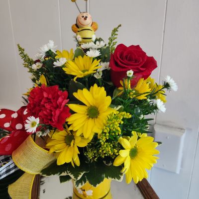 Bee Happy, Bee Well, Bee You!

A precious bee ceramic figurine sits top a bed of yellow daisies, red roses and red carnations in a keepsake tin with bees on it.